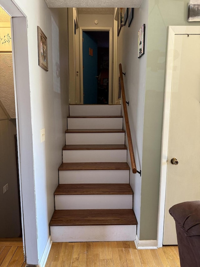 stairway with hardwood / wood-style flooring