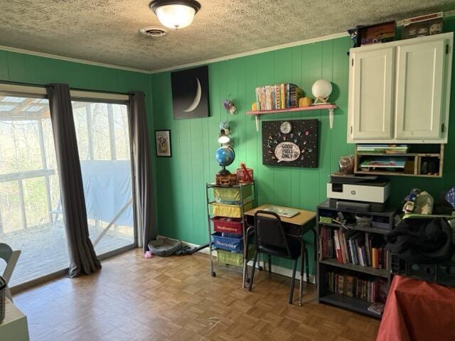 interior space featuring ornamental molding, parquet flooring, and a textured ceiling