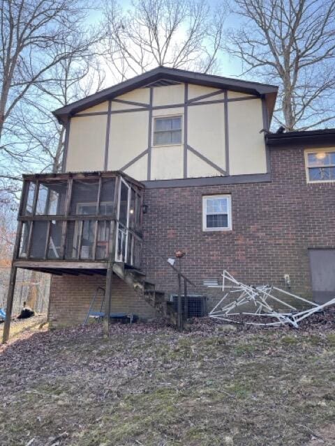 view of home's exterior with a sunroom