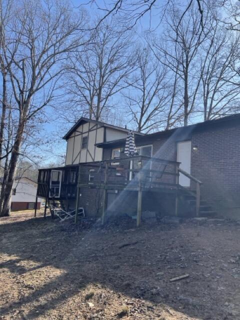 back of house featuring a wooden deck