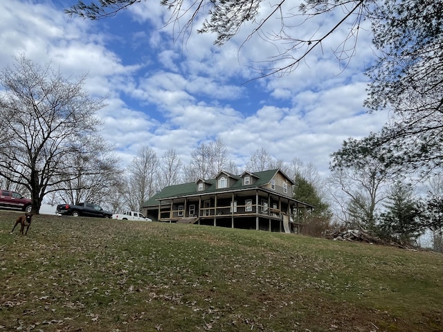 back of property with a lawn