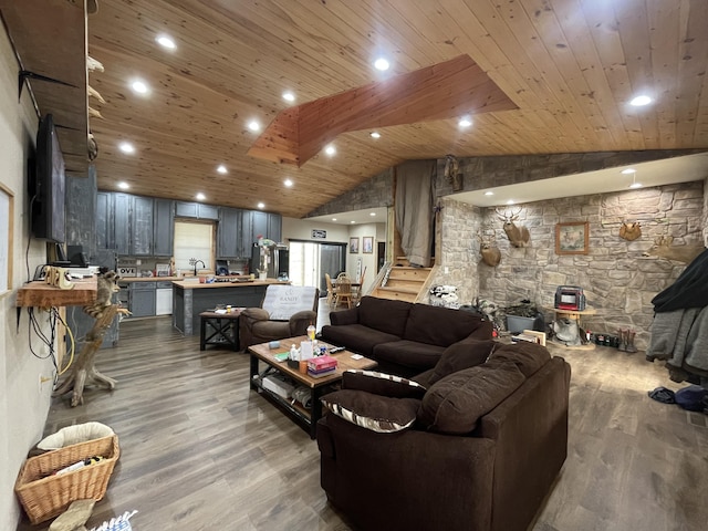 living room featuring sink, wood ceiling, hardwood / wood-style flooring, vaulted ceiling, and a wood stove