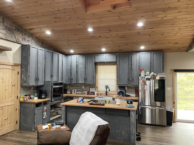 kitchen with dark wood-type flooring, gray cabinetry, wood ceiling, wooden counters, and appliances with stainless steel finishes