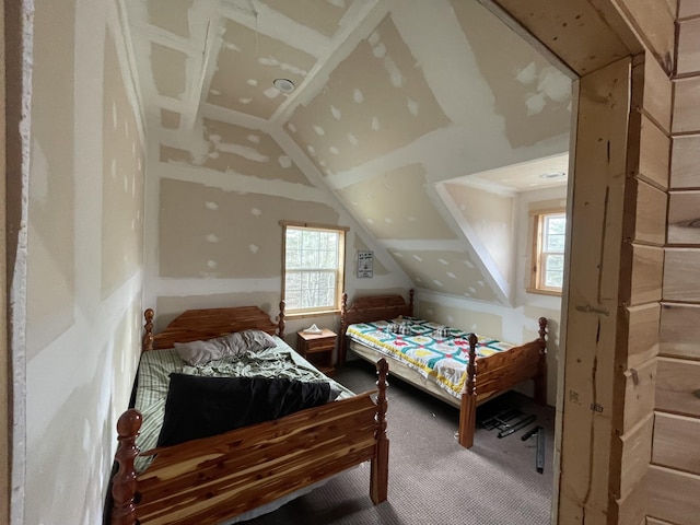 bedroom with lofted ceiling and carpet floors