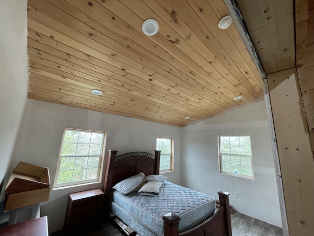 bedroom featuring vaulted ceiling, hardwood / wood-style floors, and wooden ceiling