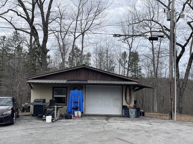 view of side of home featuring an outbuilding and a garage