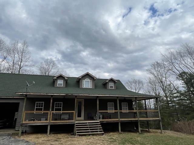 farmhouse featuring a garage and covered porch