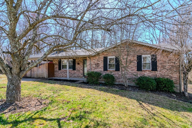 single story home with brick siding and a front lawn