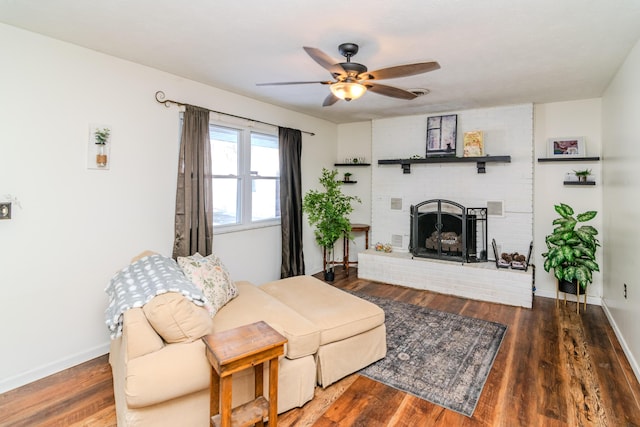 living area with ceiling fan, baseboards, wood finished floors, and a fireplace