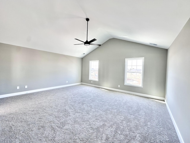 empty room with vaulted ceiling, carpet, and ceiling fan