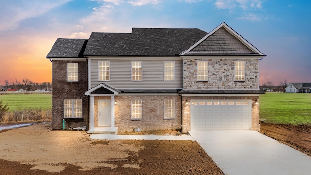 view of front of home with brick siding, roof with shingles, concrete driveway, a lawn, and a garage