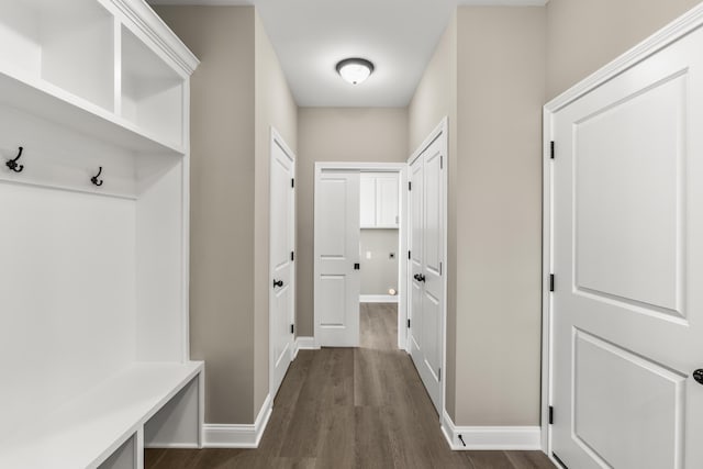 mudroom featuring dark wood finished floors and baseboards