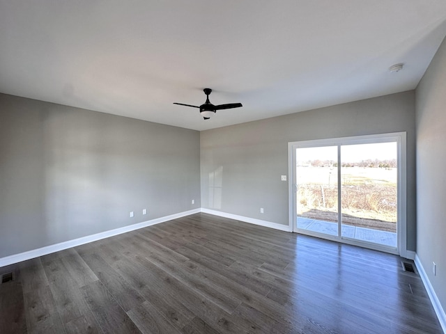 empty room featuring ceiling fan and dark hardwood / wood-style flooring