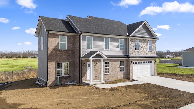 view of front of house with brick siding, roof with shingles, concrete driveway, an attached garage, and a front yard