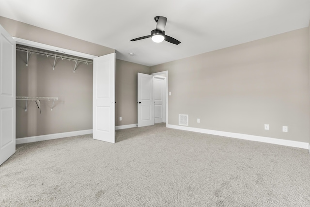 unfurnished bedroom featuring carpet floors, a closet, visible vents, and baseboards