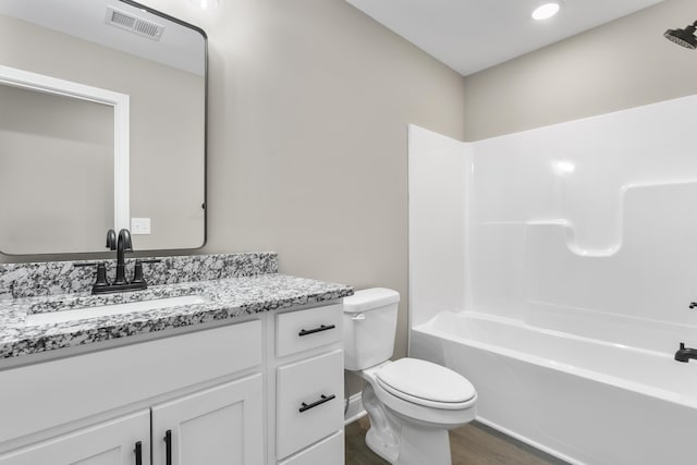 full bathroom featuring shower / bathtub combination, visible vents, toilet, vanity, and wood finished floors