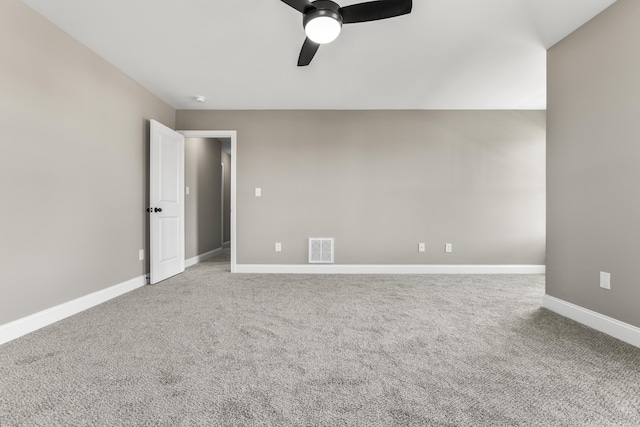 unfurnished room with a ceiling fan, carpet, visible vents, and baseboards