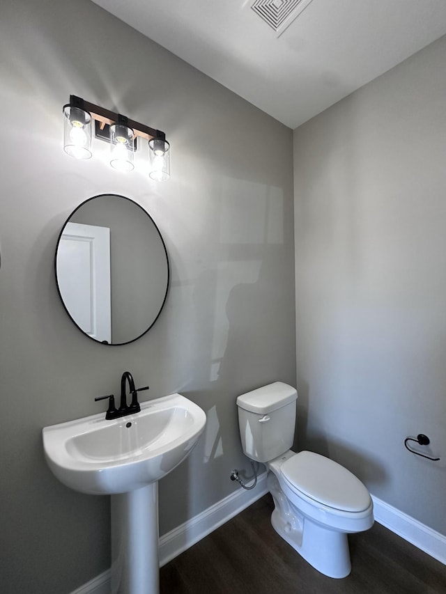 bathroom featuring sink, wood-type flooring, and toilet