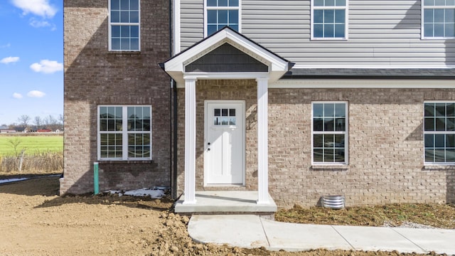 entrance to property with brick siding and crawl space