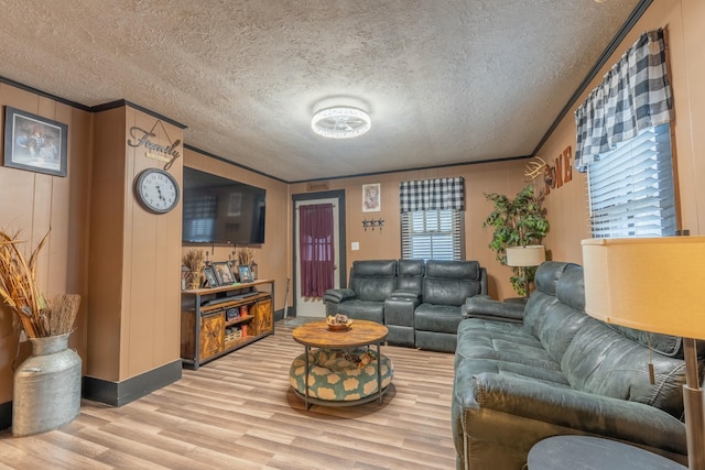 living room with hardwood / wood-style flooring, crown molding, and a textured ceiling