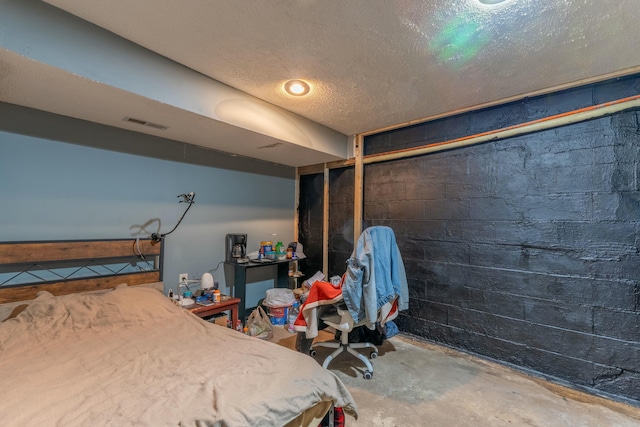 bedroom featuring concrete flooring and a textured ceiling