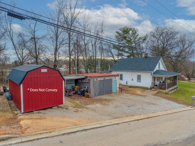 view of outdoor structure with a garage and a porch