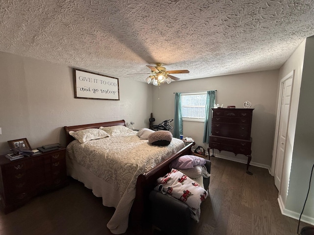 bedroom with ceiling fan, dark hardwood / wood-style flooring, and a textured ceiling