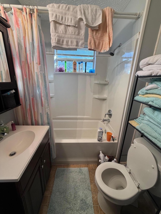 full bathroom with vanity, shower / bath combination with curtain, tile patterned floors, and toilet