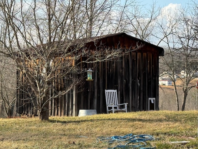 view of outbuilding featuring a yard