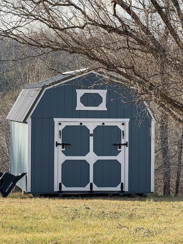 view of outbuilding with a lawn