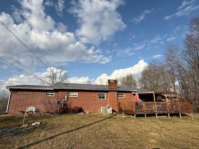 rear view of property with central AC, a lawn, and a deck