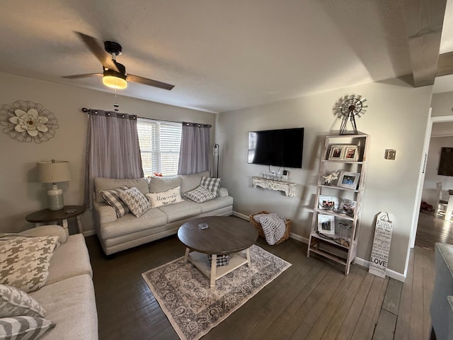 living room with dark wood-type flooring and ceiling fan