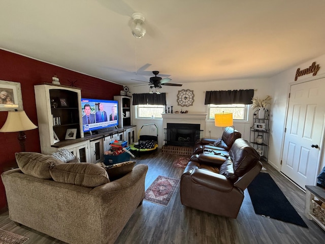 living room featuring ceiling fan, plenty of natural light, and dark hardwood / wood-style flooring