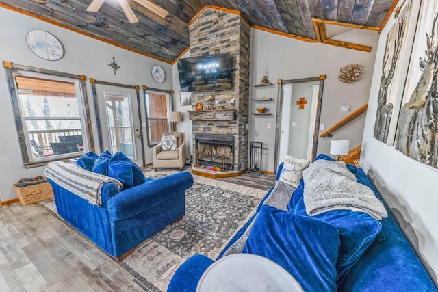 living room with a stone fireplace, wood-type flooring, lofted ceiling, ceiling fan, and wood ceiling