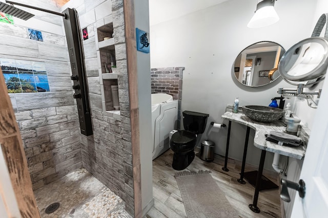 full bath with wood finished floors, a sink, a bath, a tile shower, and toilet