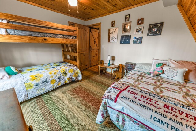 carpeted bedroom with wooden ceiling