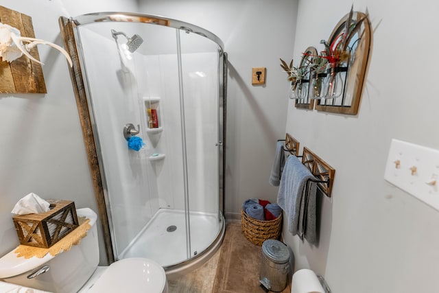 full bathroom with a shower stall and toilet