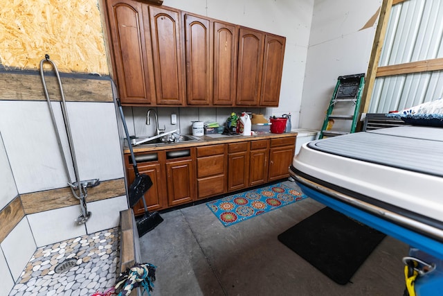 interior space featuring brown cabinets, light countertops, concrete flooring, and a sink