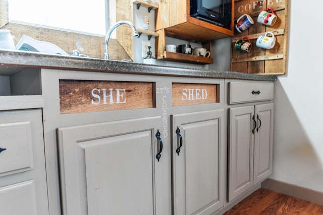 interior details with hardwood / wood-style flooring and sink