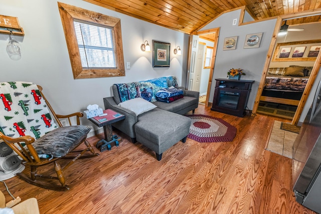 living area featuring wood ceiling, lofted ceiling, wood finished floors, and baseboards