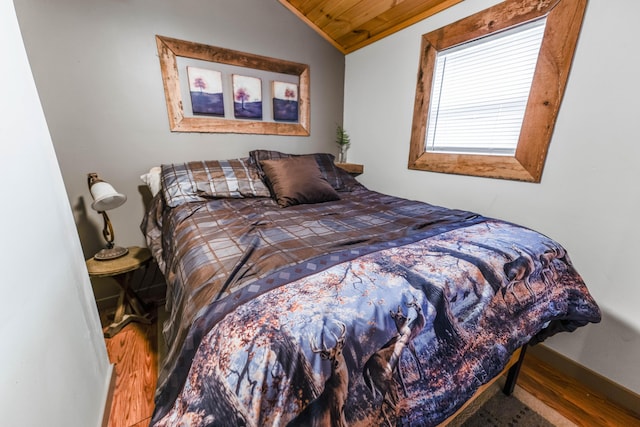 bedroom with wooden ceiling, lofted ceiling, wood finished floors, and baseboards