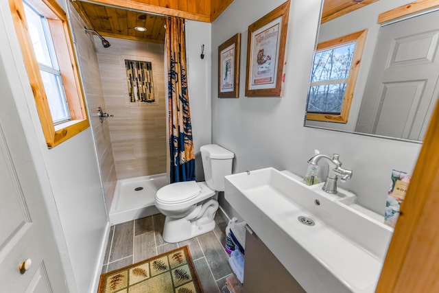 bathroom with toilet, vanity, and a shower with shower curtain