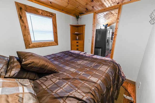 bedroom featuring wood ceiling, stainless steel refrigerator with ice dispenser, and lofted ceiling
