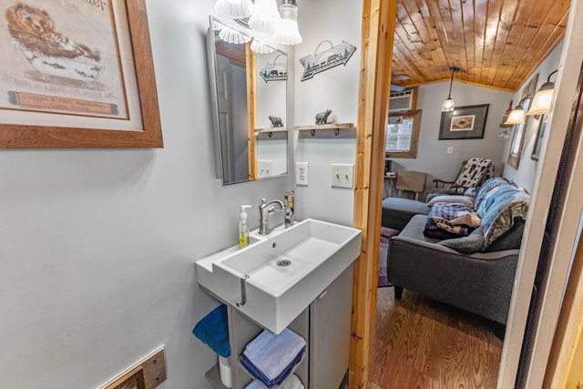 bathroom with vaulted ceiling, hardwood / wood-style floors, wooden ceiling, and vanity