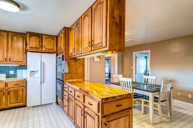 228 Jolly Ridge Rd, Richmond, KY 40475 - kitchen with white refrigerator with ice dispenser, light flooring, brown cabinetry, and wood counters