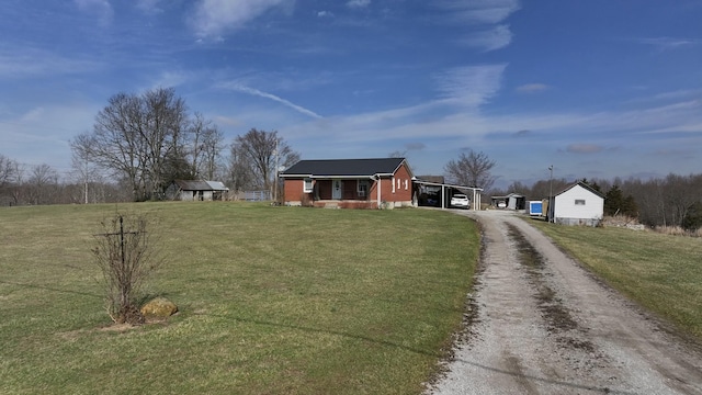 228 Jolly Ridge Rd, Richmond, KY 40475 - view of front of property featuring driveway, a front lawn, a carport, and an outdoor structure