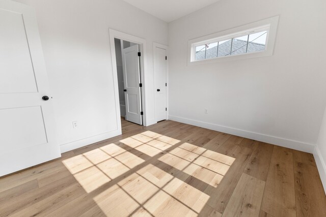 unfurnished bedroom with light wood-type flooring