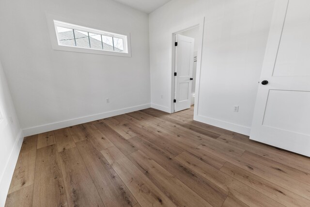 empty room featuring ceiling fan and light wood-type flooring