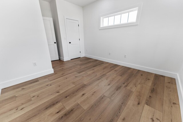 spare room featuring light hardwood / wood-style floors