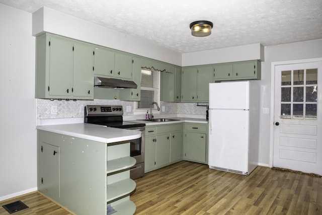 kitchen with stainless steel electric range oven, sink, white fridge, green cabinets, and dark wood-type flooring